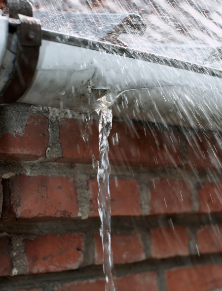 Leaking roof gutter under the rain