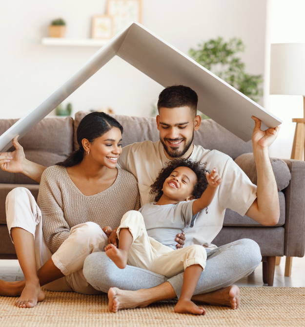  Man holding toy roof over himself and his family.